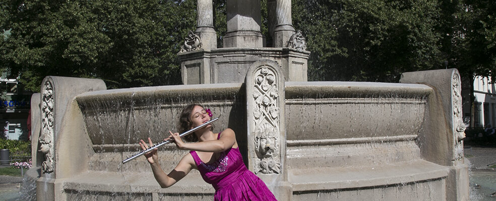 Jasmin Gundermann mit ihrer Querflöte im Brunnen in München Jasmin Gundermann mit ihrer Querflöte im Brunnen in München